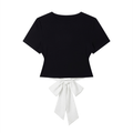 Black crop top with a white bow on a white background